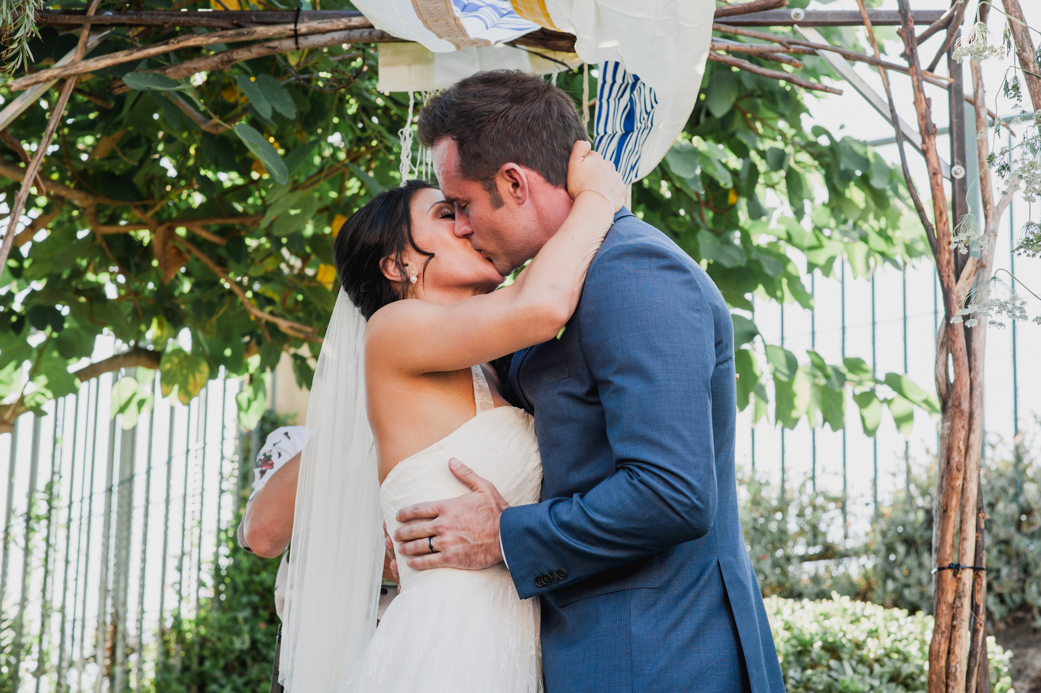 bride and groom kissat a Bohemian Backyard in Rancho Bernardo CA by Kylie Rae Photography