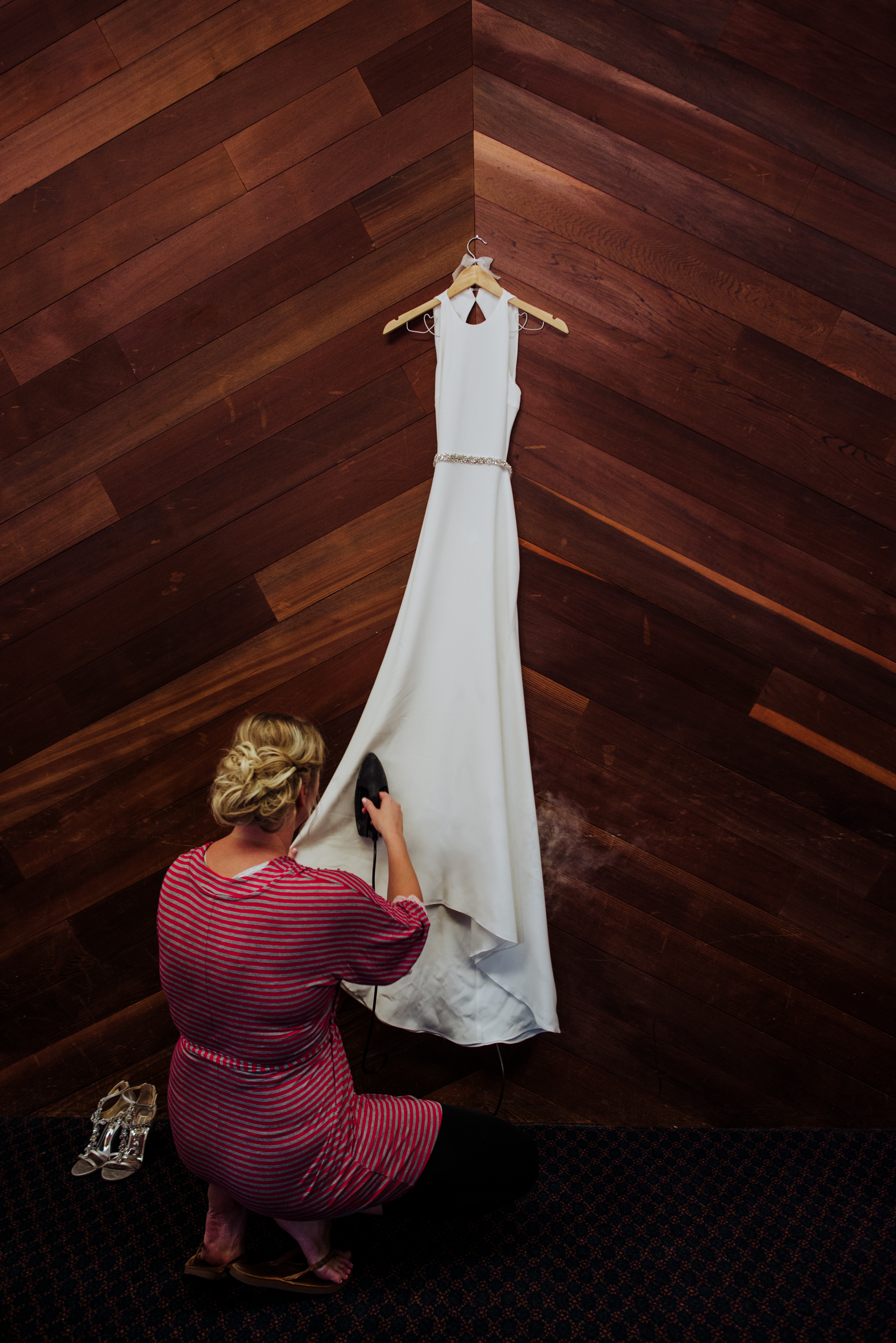 Wedding dress being steamedat a Romantic Style San Diego Wedding at Marina Village by Kylie Rae Photography