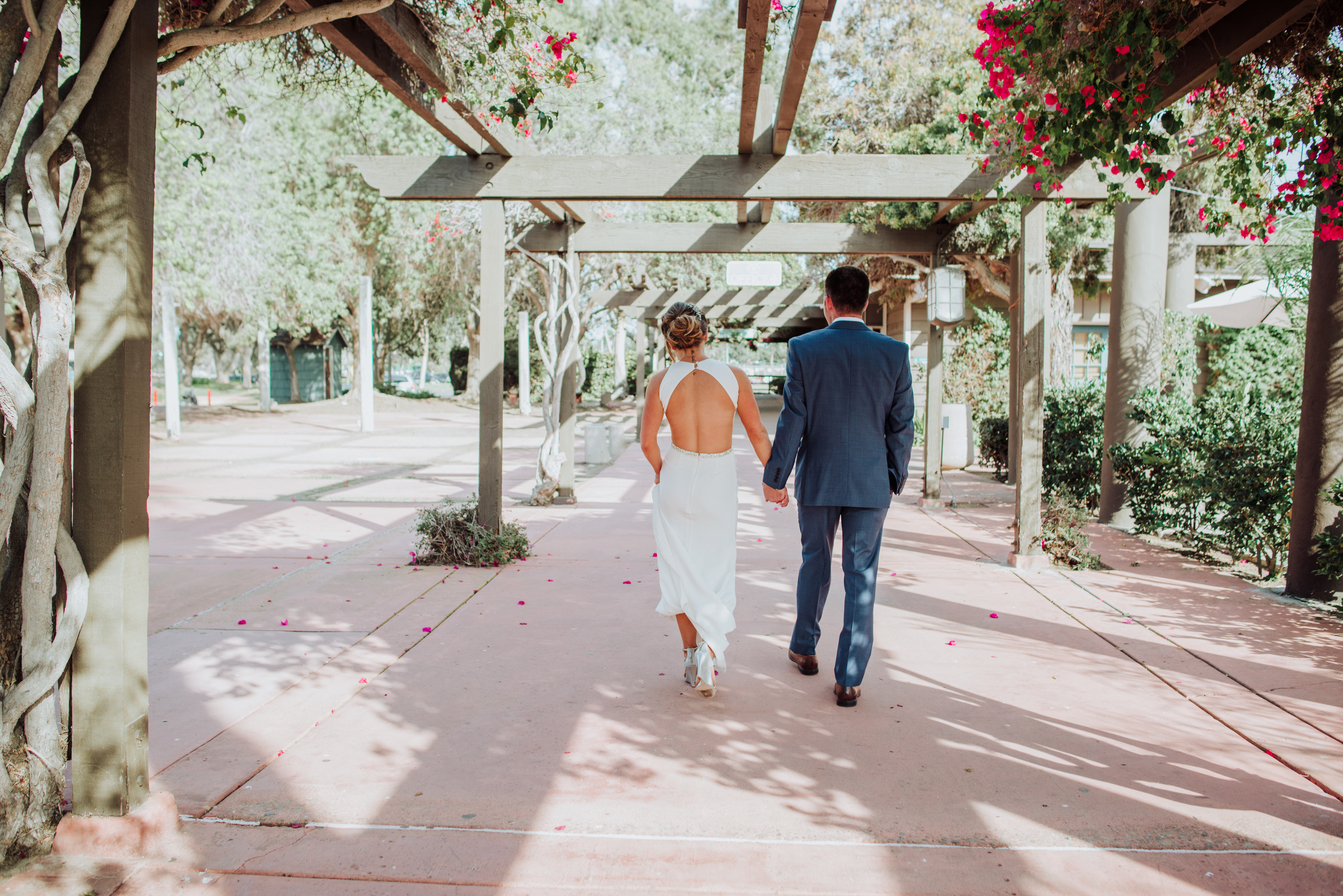 Bride and groom holding handsat a Romantic Style San Diego Wedding at Marina Village by Kylie Rae Photography