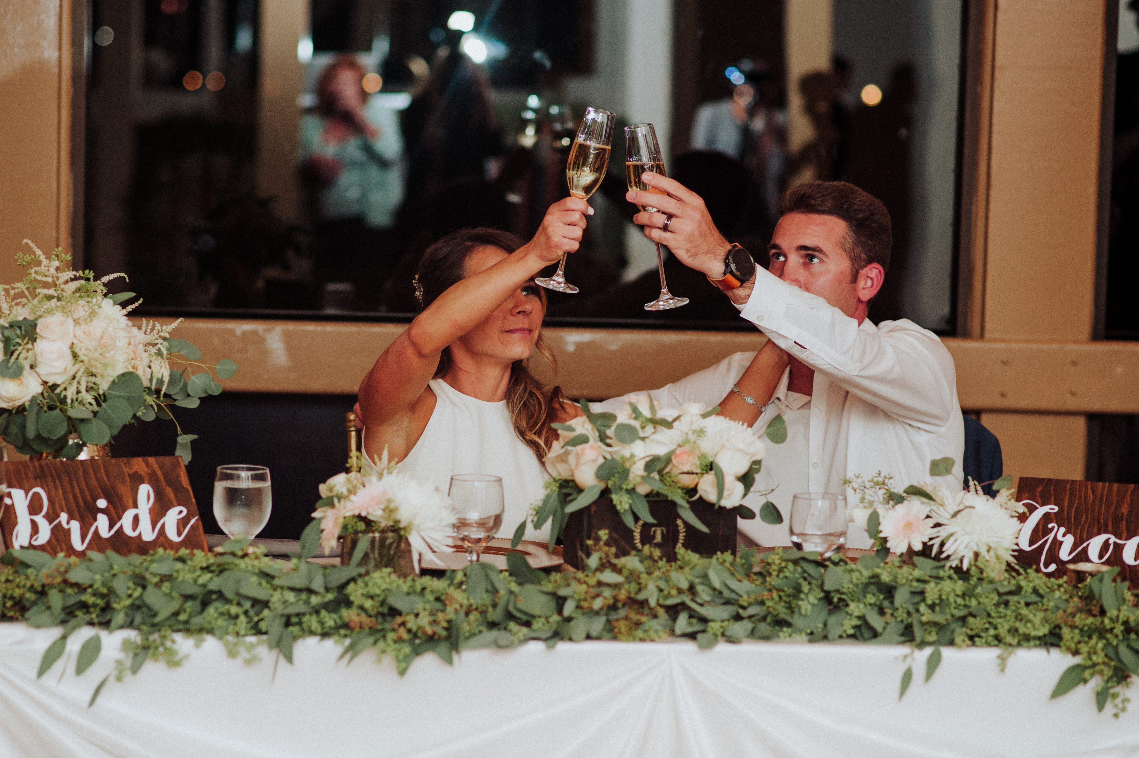 Bride and groom cheers during toastsat a Romantic Style San Diego Wedding at Marina Village by Kylie Rae Photography
