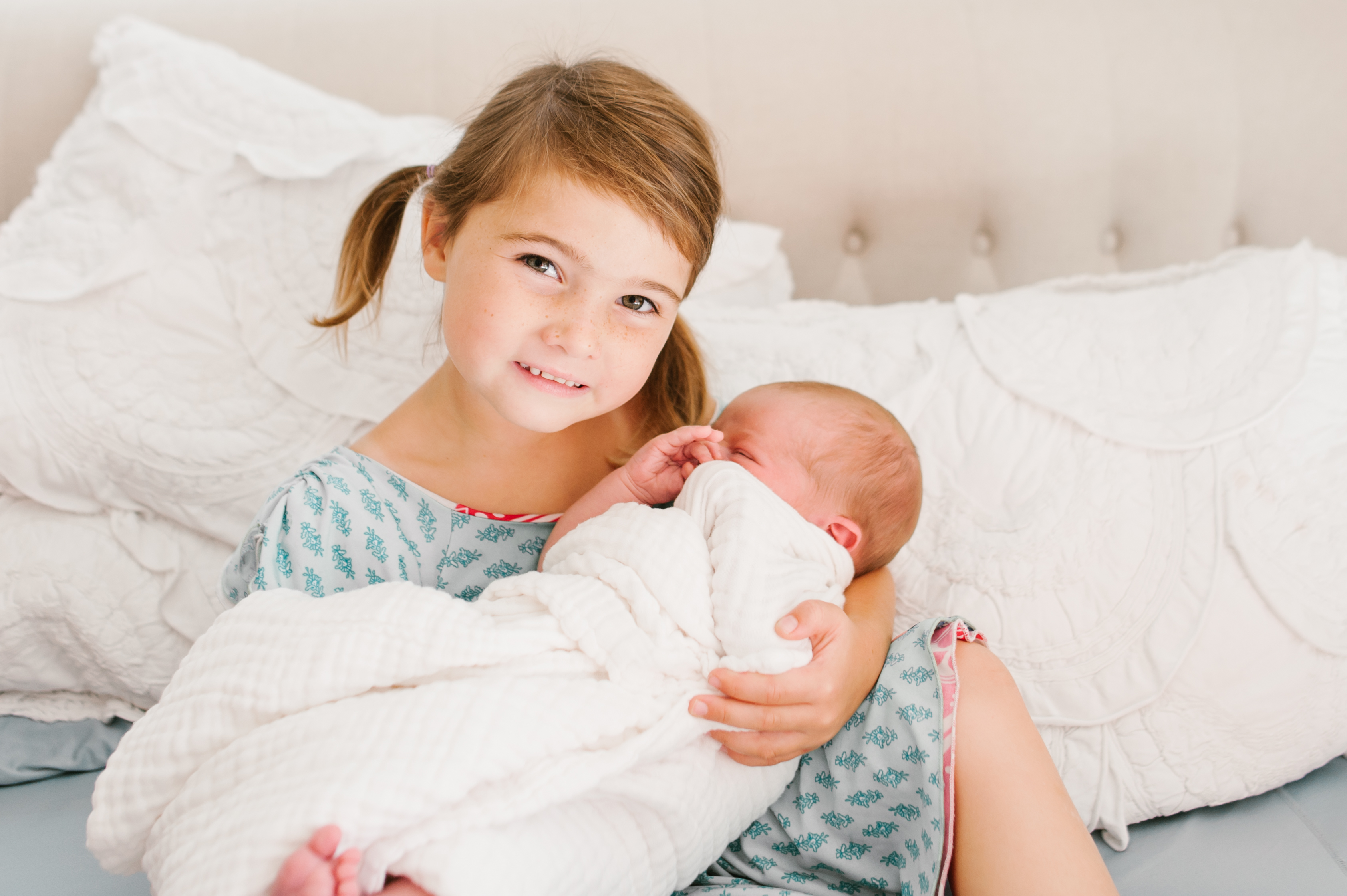 Sister holding newbornLifestyle In Home Family Session by Kylie Rae Photography