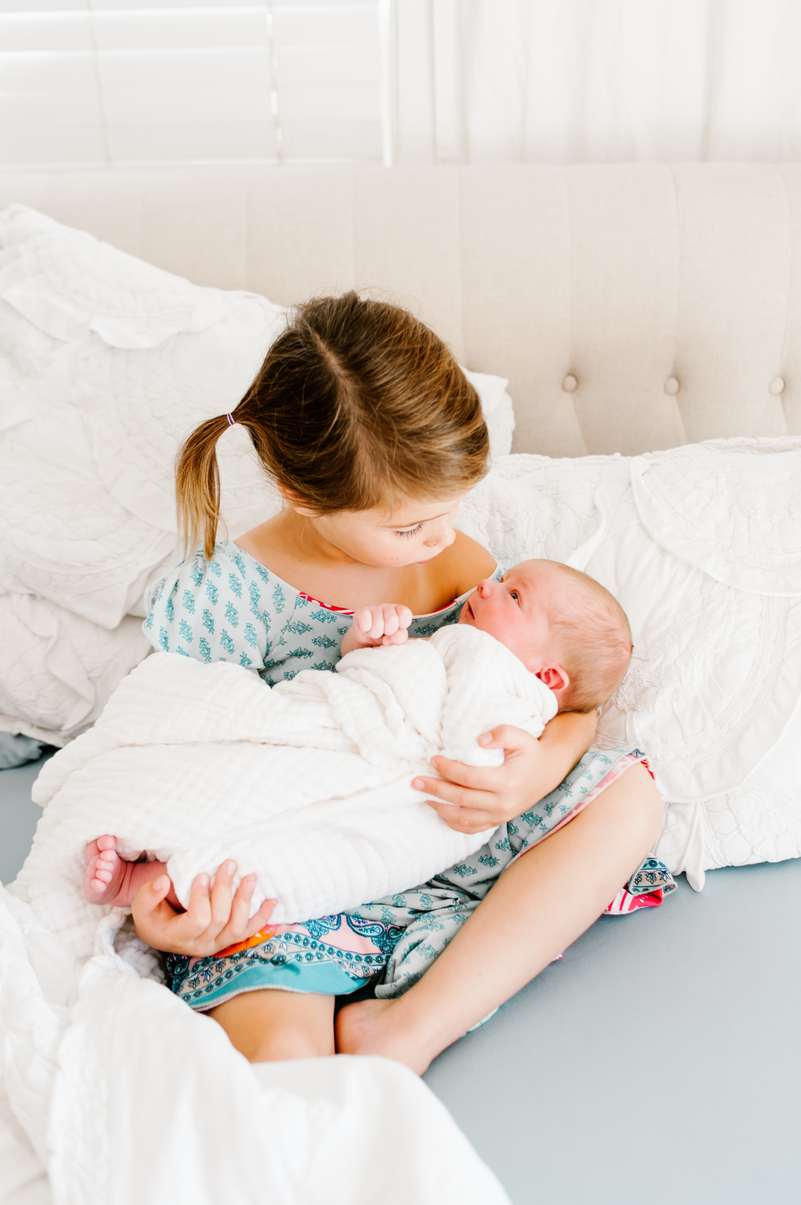Sister holding newbornLifestyle In Home Family Session by Kylie Rae Photography